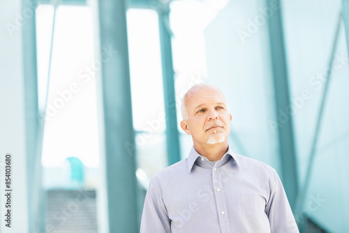 Senior businessman looking up with hope and concern about the fu