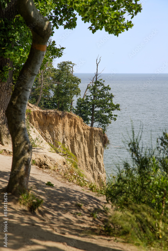 Landscape with a sandy cliff on a sunny summer day with the sea in the background. Landscape with a sandy cliff on a sunny summer day with the sea in the background.