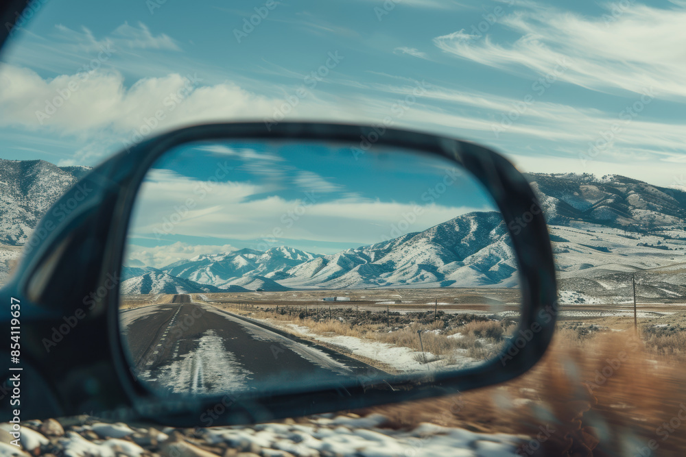 Fototapeta premium View of mountains in side mirror of car on roadtrip