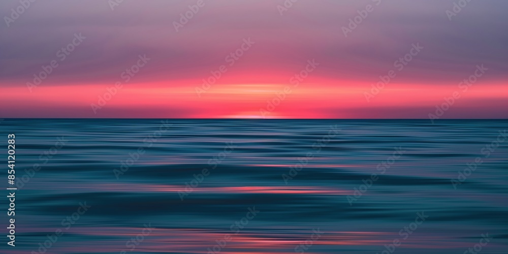 Obraz premium Serene ocean sunset. Blurred horizon with pink and blue hues.