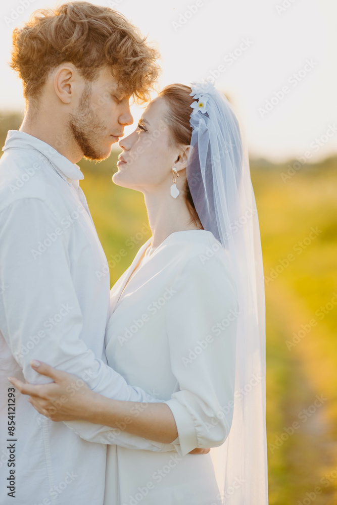 newlywed couple in love in a field in nature at sunset in summer newlywed couple in love in a field in nature at sunset in summer