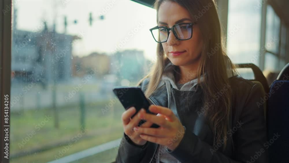 Public transport. Woman in tram using smartphone. Public transport. Woman in tram using smartphone.