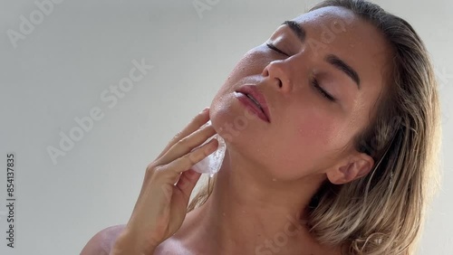 Beautiful woman doing facial beauty spa treatment with ice