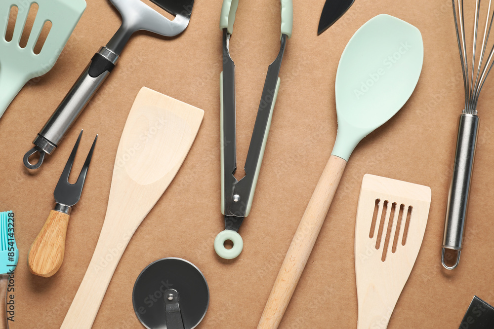 Different spatulas and other kitchen utensils on brown background, flat lay Different spatulas and other kitchen utensils on brown background, flat lay
