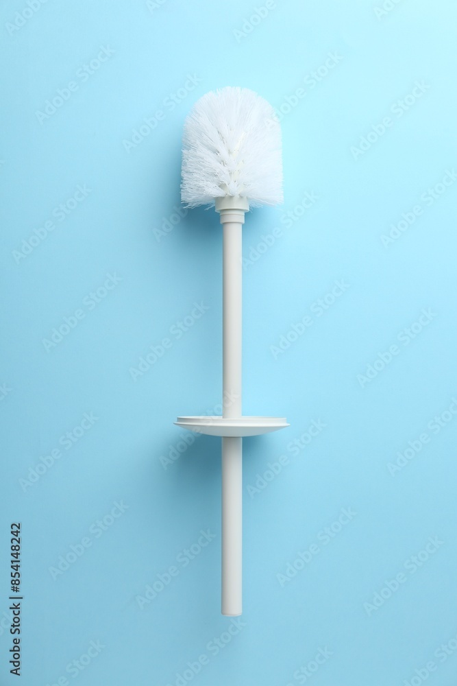 Toilet brush on light blue background, top view Toilet brush on light blue background, top view