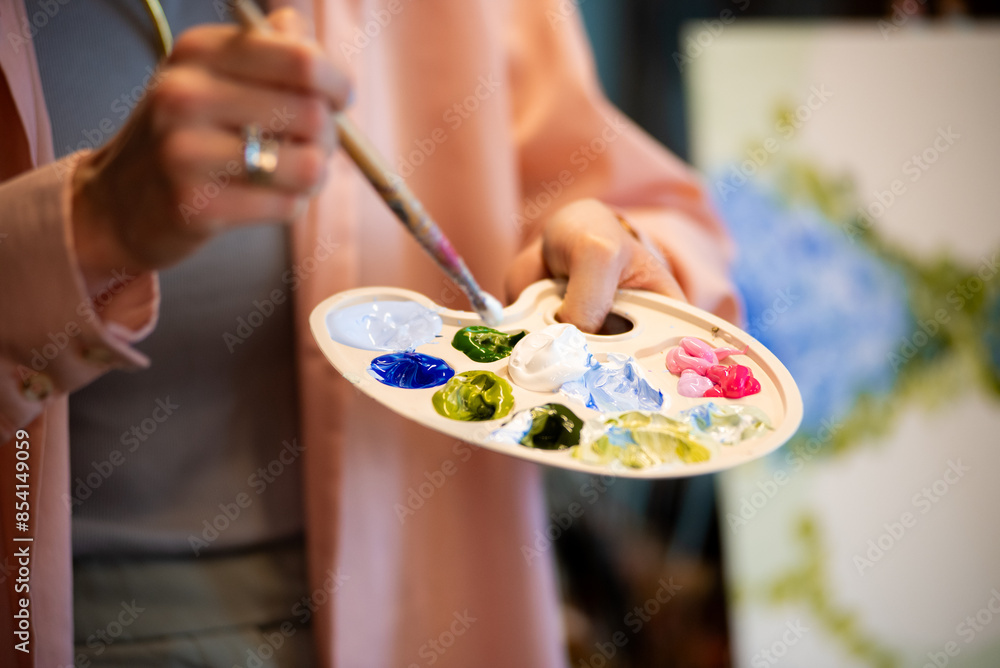 female hands painting a picture. artist painting oil paint on canvas. female hands painting a picture. artist painting oil paint on canvas.