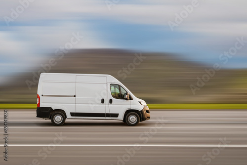Cargo van is driving on the highway at speed with a blurred background. Freight transport, commercial transport concept with free space for text, copy space