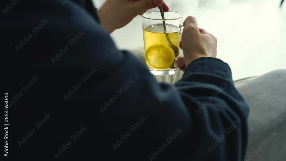 A man with a glass cup in his hands drinks tea.
Green tea in a transparent glass A man with a glass cup in his hands drinks tea.
Green tea in a transparent glass