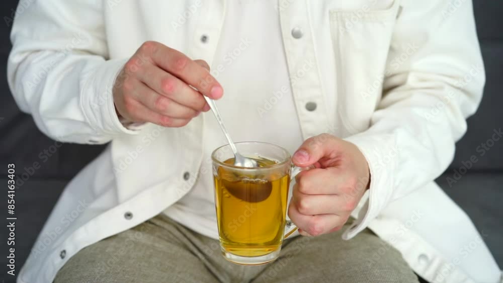 Green tea in a transparent cup.
A man stirs tea with a teaspoon.
Hot tea with takane Green tea in a transparent cup.
A man stirs tea with a teaspoon.
Hot tea with takane