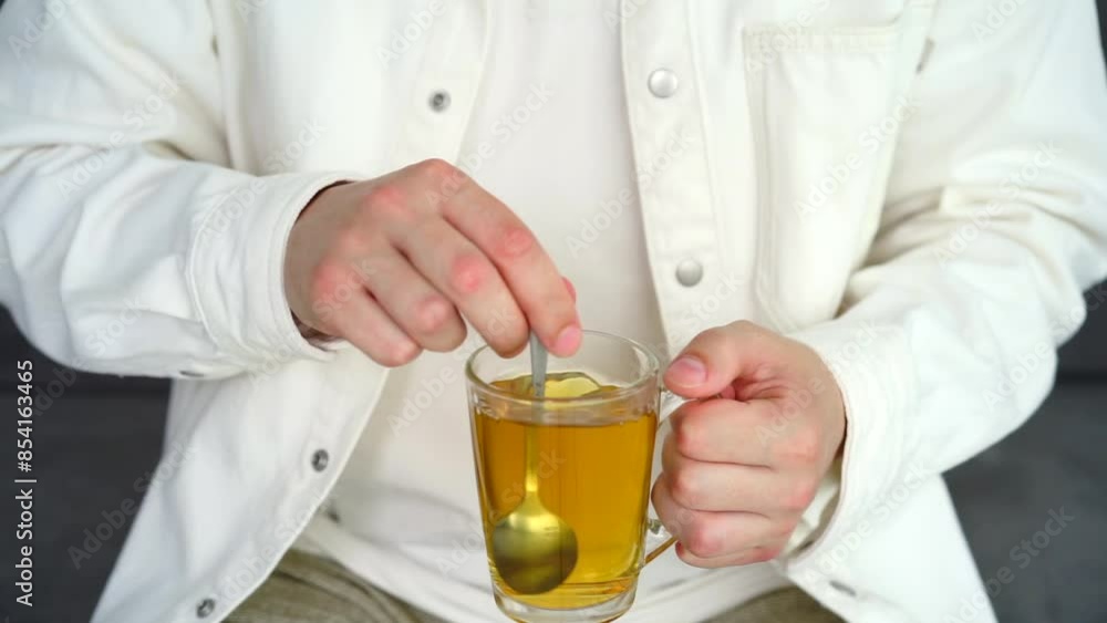 Green tea in a transparent cup.
A man stirs tea with a teaspoon.
Hot tea with takane Green tea in a transparent cup.
A man stirs tea with a teaspoon.
Hot tea with takane