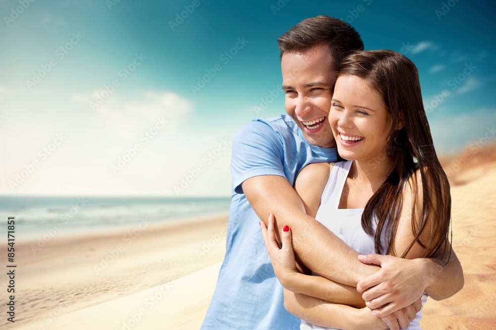 Happy young couple enjoying at the beach.