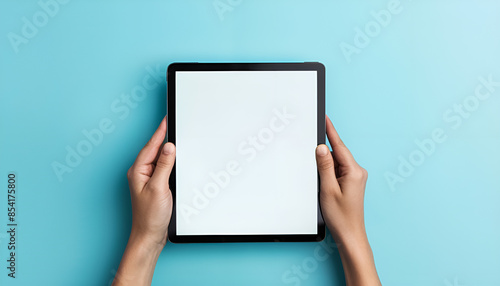 Human hands holding digital tablet with a white blank screen