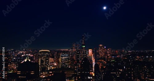 Wallpaper Mural The Moon in the dark blue sky over the scenery of New York. Vast city view at night from aerial perspective. Torontodigital.ca