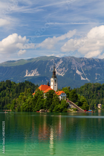 Bled, A church on the beautiful european lake Slovenia with castle on the nearby hill and mountain in the background. 