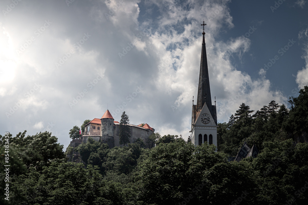 A Bled castle old medival on the high cliff rock near the lake. Church top on the right. A Bled castle old medival on the high cliff rock near the lake. Church top on the right.