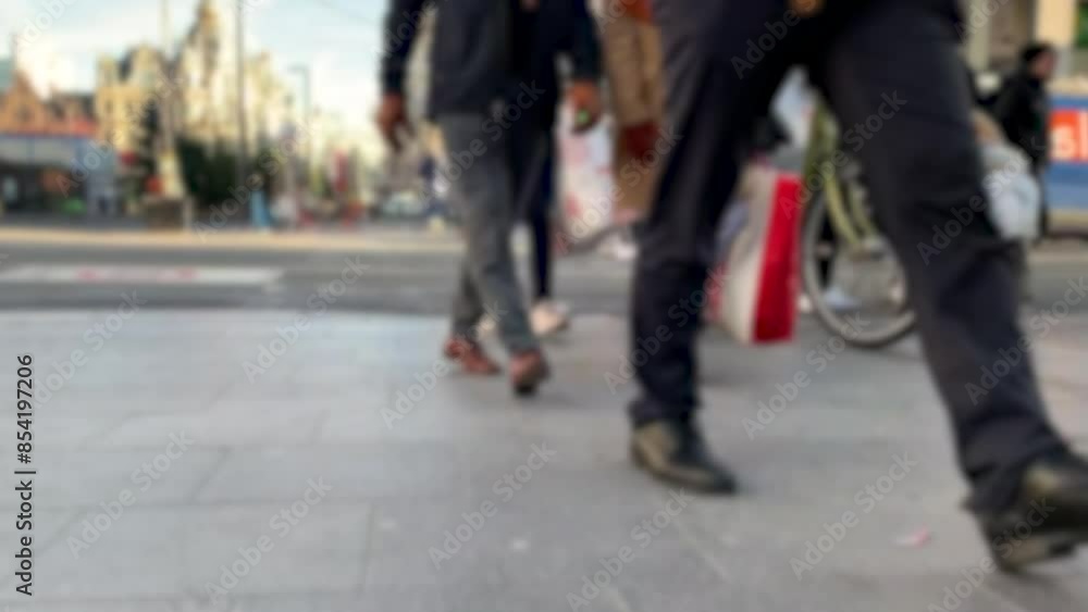 The city street is filled with a bustling crowd of people, strolling and lugging shopping bags The city street is filled with a bustling crowd of people, strolling and lugging shopping bags