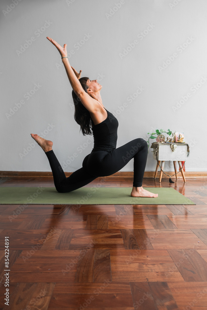 Slender woman practicing a variation of the low Lunge yoga pose. Stock ...
