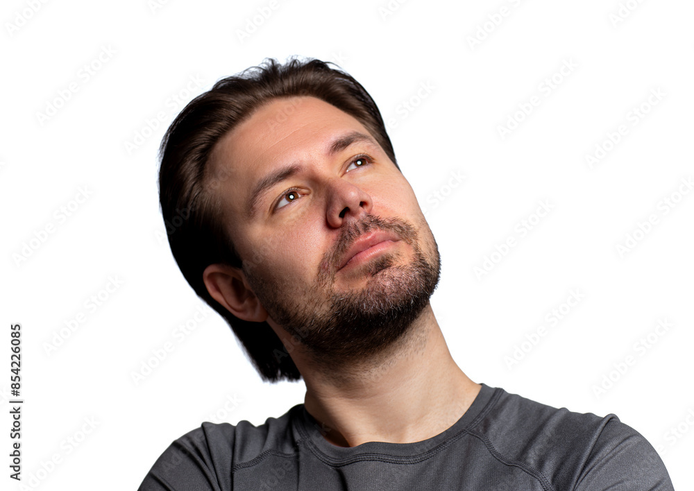 Obraz premium Young handsome man optimistically looking up, portrait isolated on white background