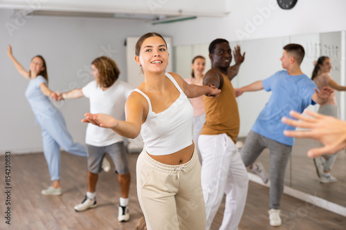 Adult couples dancing active dance together in modern studio