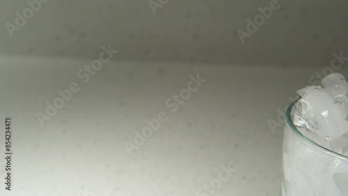 track shot of a strawberry on a glass full of ice