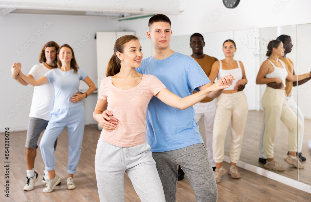 Fototapeta premium Young girl and teen boy dancing pair dance in dance hall
