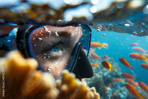 Diver wearing a diving mask is exploring the underwater world photo