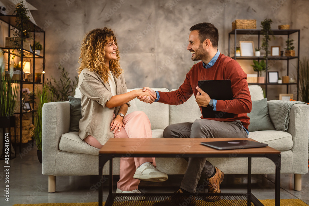 Obraz premium Man financial adviser shake hands with woman customer, client