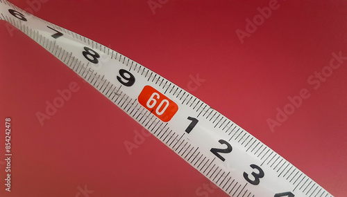 Quadro su tela Measuring tape on a pink background