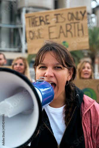 Photography Vertical close up portrait nonconformist gen z activist woman shouting at protest holding megaphone
