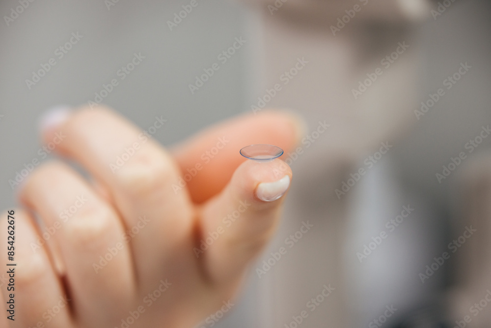Concept of vision correction and maintenance. Close-up of a contact lens on a light background. Concept of vision correction and maintenance. Close-up of a contact lens on a light background.