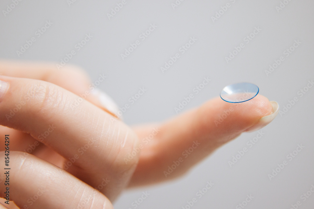 Concept of vision correction and maintenance. Close-up of a contact lens on a light background. Concept of vision correction and maintenance. Close-up of a contact lens on a light background.