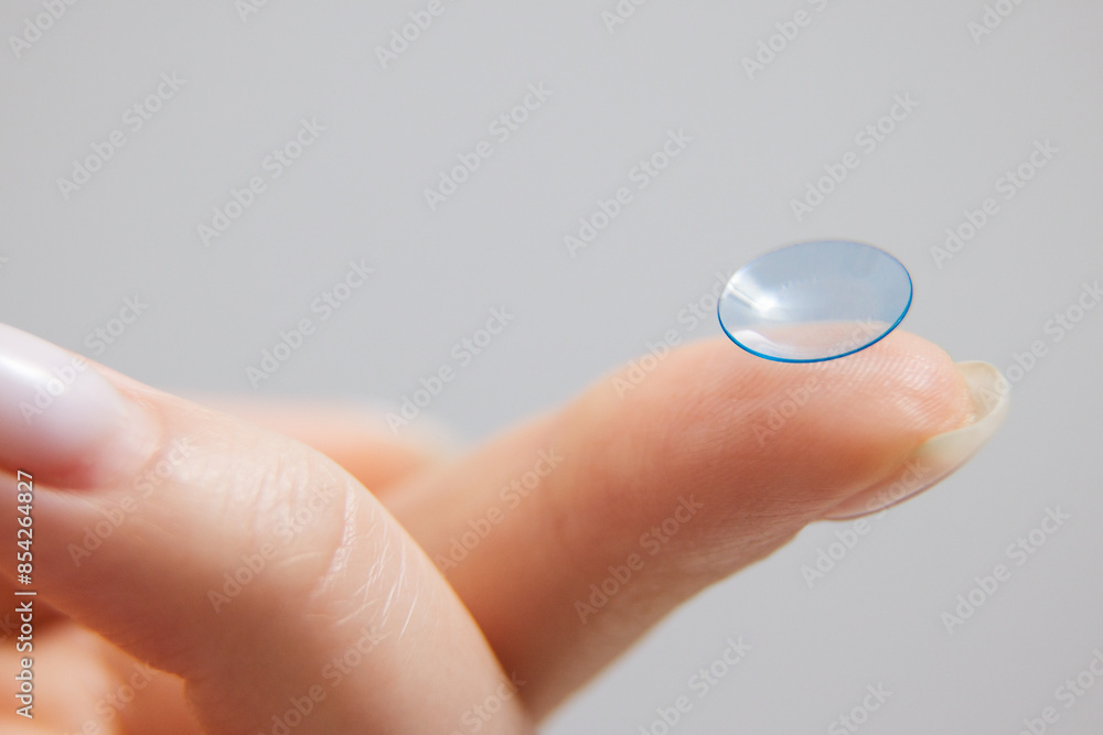 Concept of vision correction and maintenance. Close-up of a contact lens on a light background. Concept of vision correction and maintenance. Close-up of a contact lens on a light background.