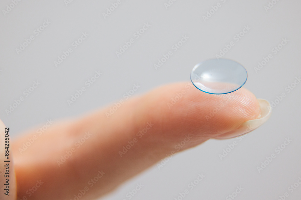 Concept of vision correction and maintenance. Close-up of a contact lens on a light background. Concept of vision correction and maintenance. Close-up of a contact lens on a light background.