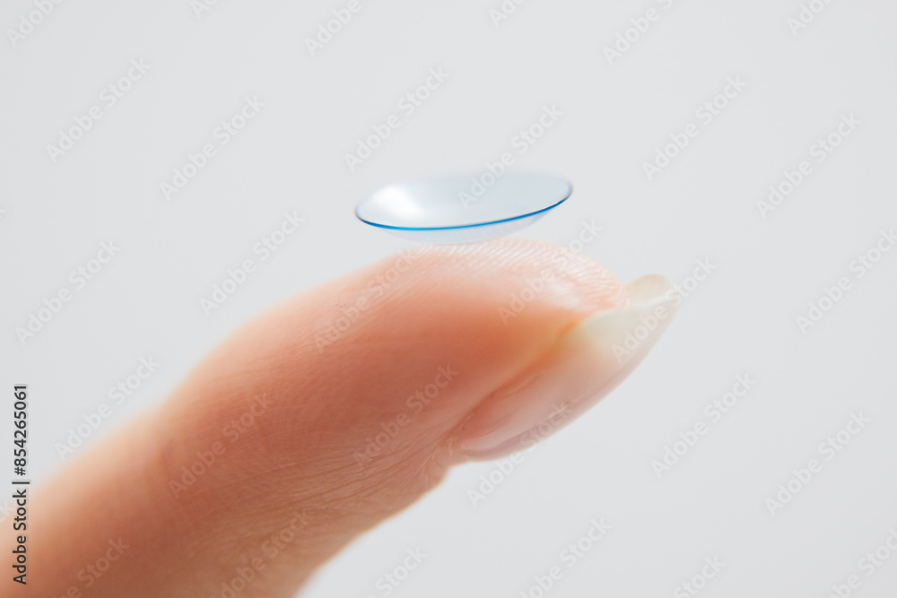 Contact lenses for vision correction. A woman holds a contact lens on her finger, close-up. Contact lenses for vision correction. A woman holds a contact lens on her finger, close-up.