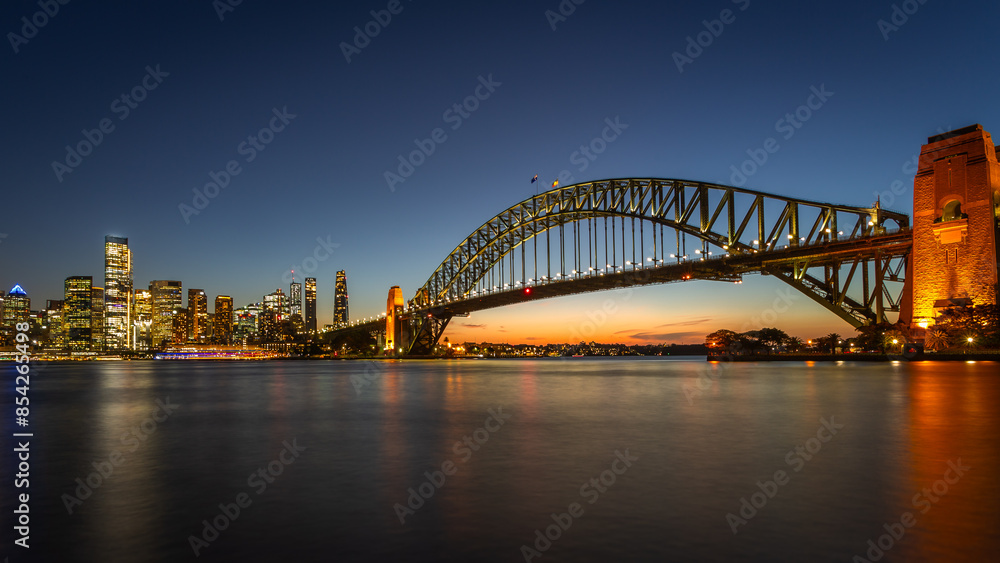 Long exposure of the amazing Sydney Harbour Bridge and Sydney's Downtown from the north bank namely Mattawunga at sunset Long exposure of the amazing Sydney Harbour Bridge and Sydney's Downtown from the north bank namely Mattawunga at sunset