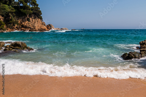 beach in Cala Sa Boadella Bay, Costa Brava, Lloret de Mar, Catalonia, Spain. Beautiful seascape. huge waves photo