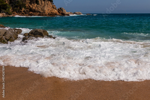 beach in Cala Sa Boadella Bay, Costa Brava, Lloret de Mar, Catalonia, Spain. Beautiful seascape. huge waves photo