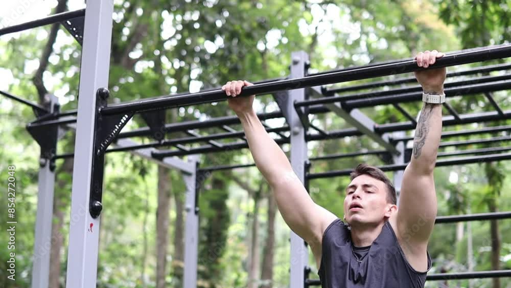 man in sportswear doing barbells in a street gym man in sportswear doing barbells in a street gym