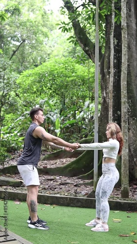couple in sports clothes exercising in a park