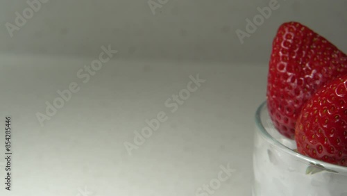 traveling shot of strawberries in a glass