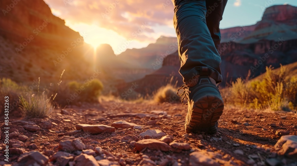 Closeup view of a hiker hiking in rugged land with majestic view.