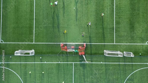 campo da calcio in erba sintetico in una campagna visto dall'alto photo