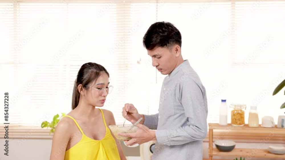 Beautiful pregnant mom and dad make healthy salad to eat together on weekend mornings. Young couple spending time together during cooking time. Family love healthy eating vegetable salad concept. Beautiful pregnant mom and dad make healthy salad to eat together on weekend mornings. Young couple spending time together during cooking time. Family love healthy eating vegetable salad concept.