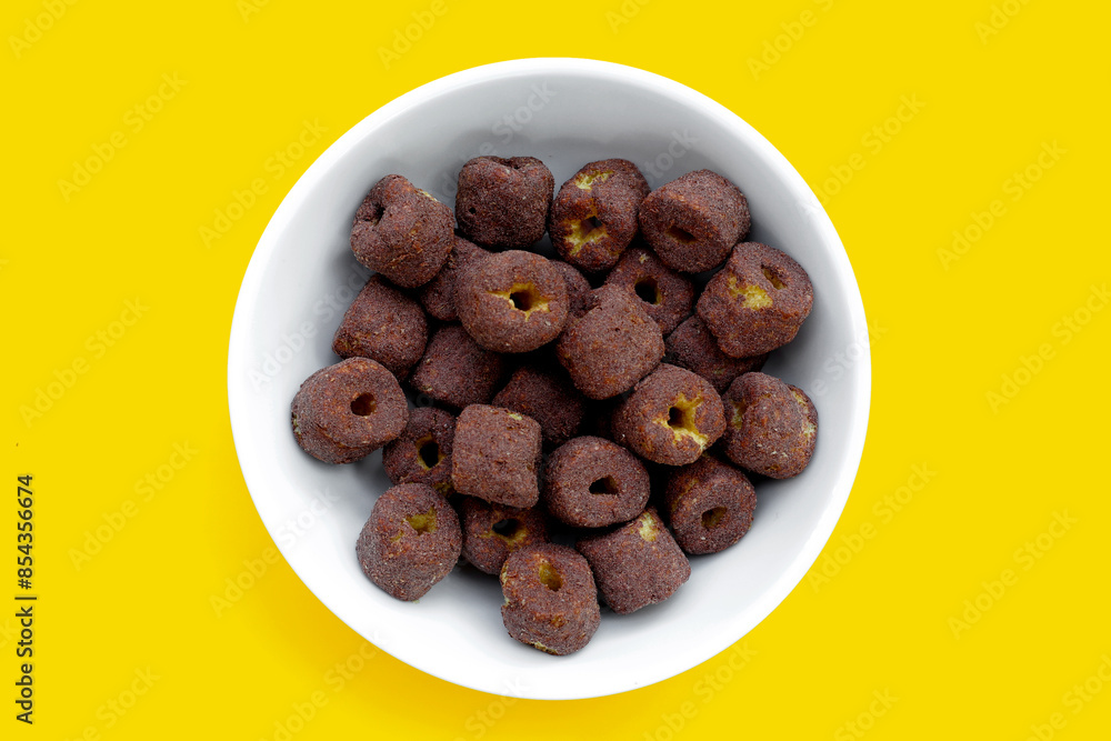 Corn snack chocolate flavor on yellow background. Corn snack chocolate flavor on yellow background.