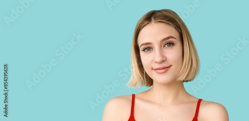 Peaceful smile. Optimistic expression. Lovely mood. Young charming woman enjoying life portrait isolated on blue empty space.