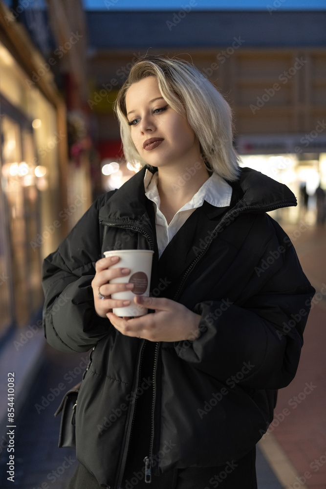Portrait of a young beautiful blonde girl in an evening spring city. Portrait of a young beautiful blonde girl in an evening spring city.