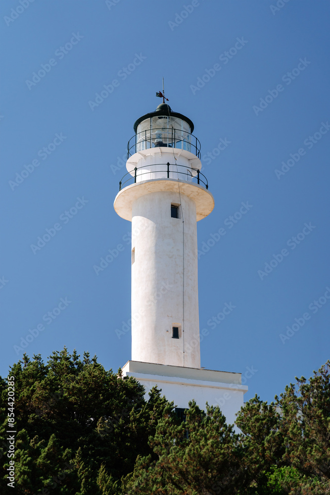 Tall white lighthouse, with a clear blue sky backdrop, symbolizing guidance, safety, and navigation for ships at sea. Tall white lighthouse, with a clear blue sky backdrop, symbolizing guidance, safety, and navigation for ships at sea.
