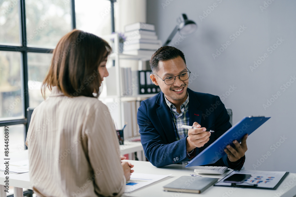 Business Meeting in Modern Office with Smiling Professional Discussing Documents with Colleague Business Meeting in Modern Office with Smiling Professional Discussing Documents with Colleague