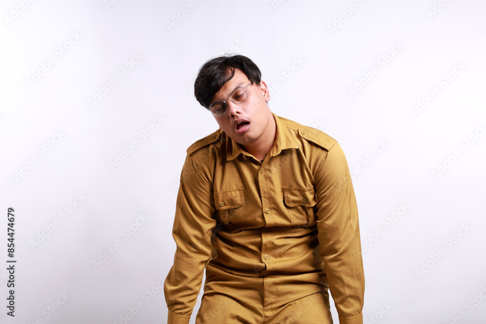 Tired Indonesian government employees while standing. Isolated on white background Tired Indonesian government employees while standing. Isolated on white background