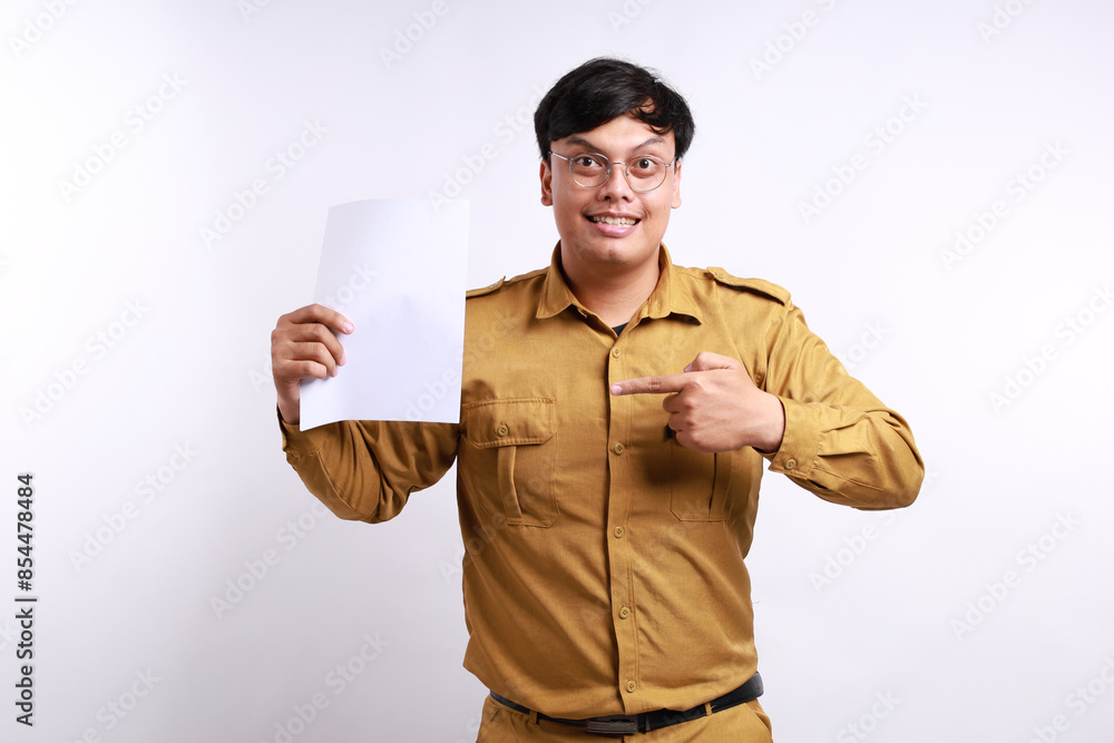Excited Indonesian government employees standing while holding and showing a document or paper Excited Indonesian government employees standing while holding and showing a document or paper